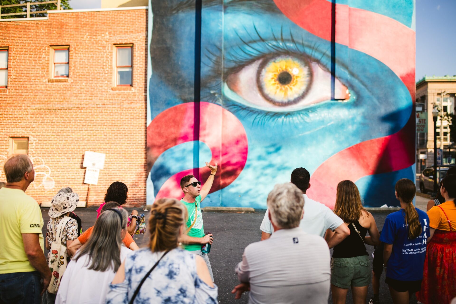 A tour checks out The Eye, a mural by Nick Napoletano